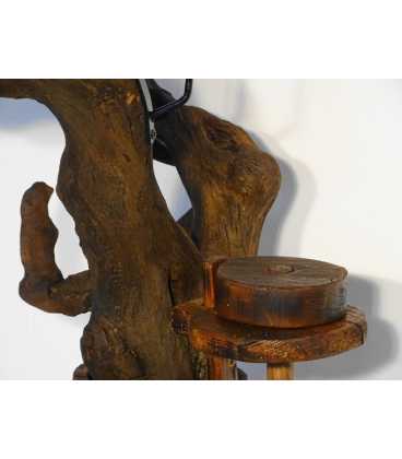 Candle holder formed of a tree root and an old butter churn